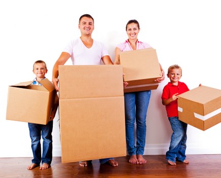 Professional flat removals team handling boxes and furniture in West Kensington