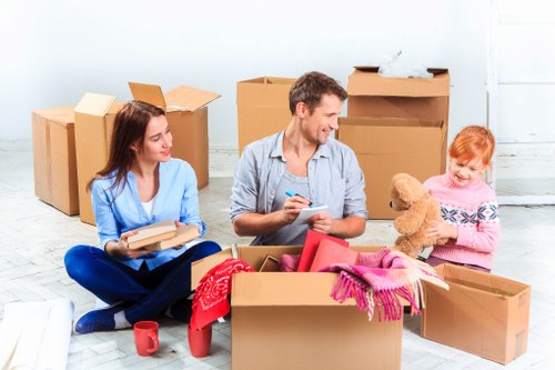 Moving crew handling office items in a busy West Kensington street