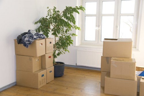 Staff using safe lifting and loading methods with moving equipment