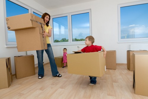 Loading old household furniture into a collection vehicle in West Kensington
